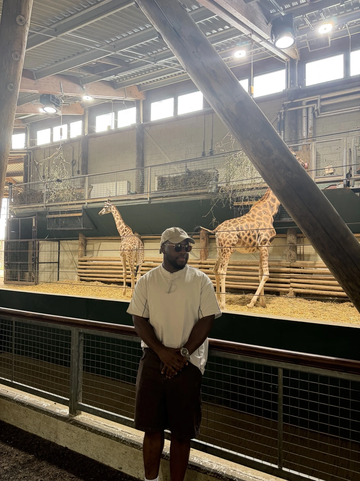 Funnso visiting the giraffe enclosure at a zoo