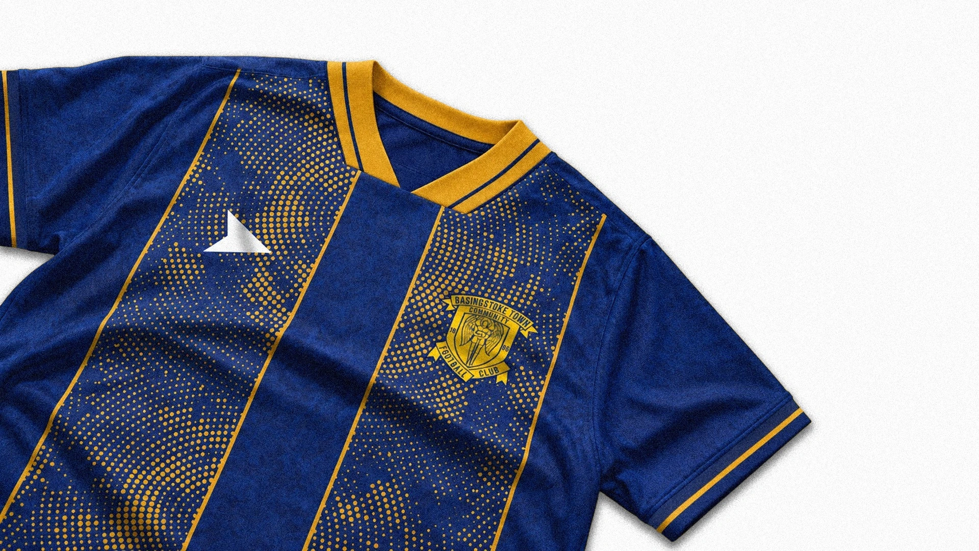 Close-up of the Basingstoke home shirt on a white background, showing its yellow collar, circular dotted stripes and club crest