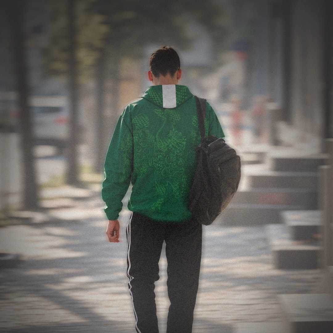 Nigeria green windbreaker worn outdoors, showing the flag-inspired hood and tonal eagle graphic across the back and sleeves